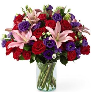 This bouquet is "Truly Stunning" with is array of beautiful blooms which include roses, lilies, lisianthus and more professionally arranged and presented in a clear glass vase. Approximate size: 14"h x 13"w 