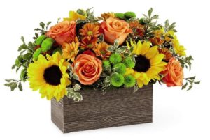 sunflowers with orange roses and green accents in rectangular box