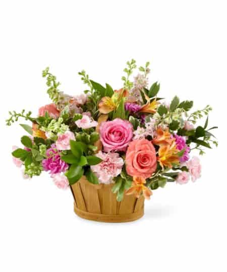 A glorious assortment of roses, larkspur, carnations, alstroemeria and more in shades of pink, peach and white make this basket a true beauty. Our Lift Me Up basket will brighten her day and make her heart soar. * Basket style will vary