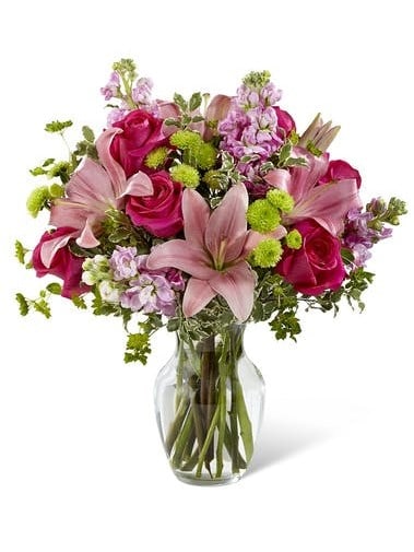 celebrate one on life's sweetest moments with this chic pink and lavender bouquet. Pink lilies, roses and and much more are professionally arranged and presented in a classic clear vase. 
