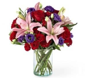 This bouquet is "Truly Stunning" with is array of beautiful blooms which include roses, lilies, lisianthus and more professionally arranged and presented in a clear glass vase.